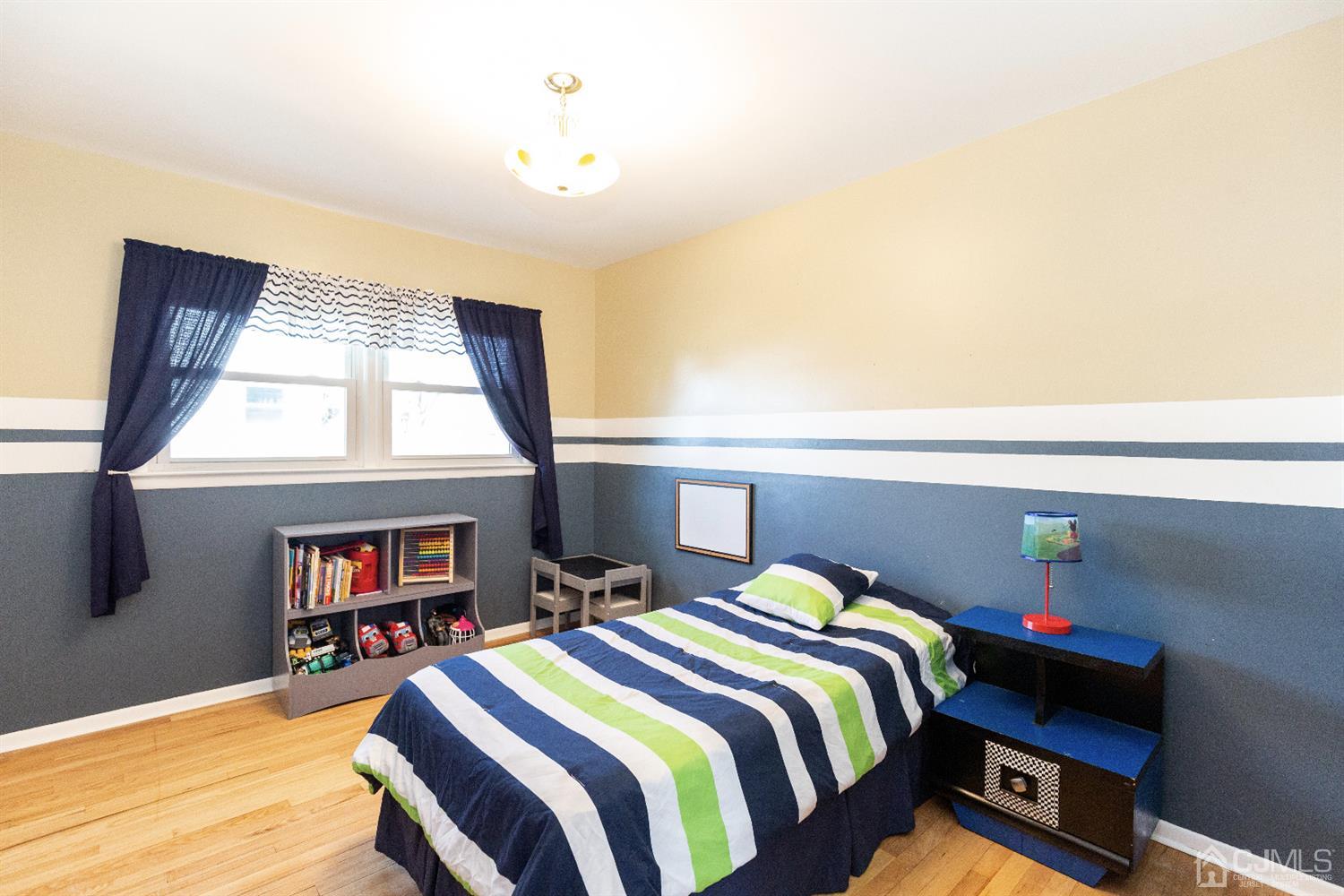 28 Melville Road Edison, NJ 08817 - Photo 15 of 52 a bedroom with a bed and a bookshelf