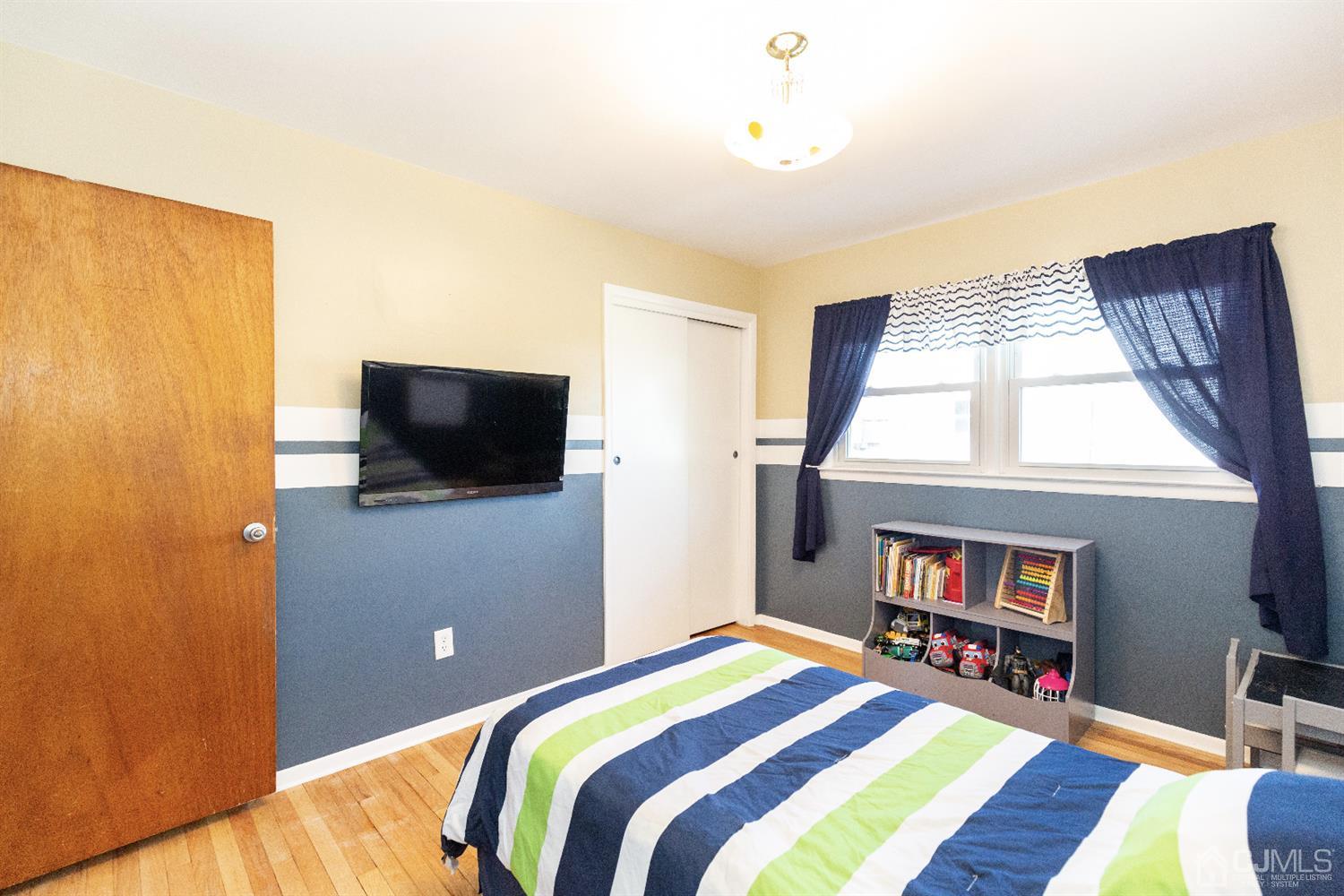 28 Melville Road Edison, NJ 08817 - Photo 16 of 52 a bed room with a bed and a television