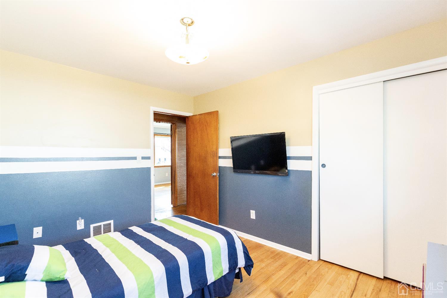 28 Melville Road Edison, NJ 08817 - Photo 17 of 52 a bedroom with a bed and a television