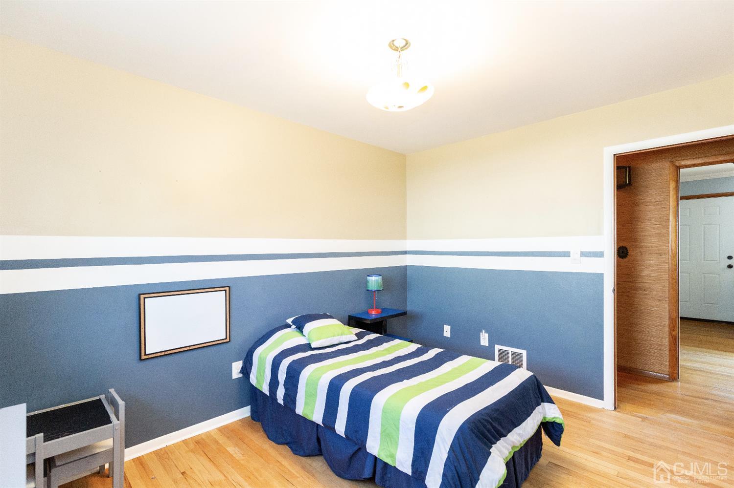 28 Melville Road Edison, NJ 08817 - Photo 18 of 52 a bedroom with a bed and wooden floor