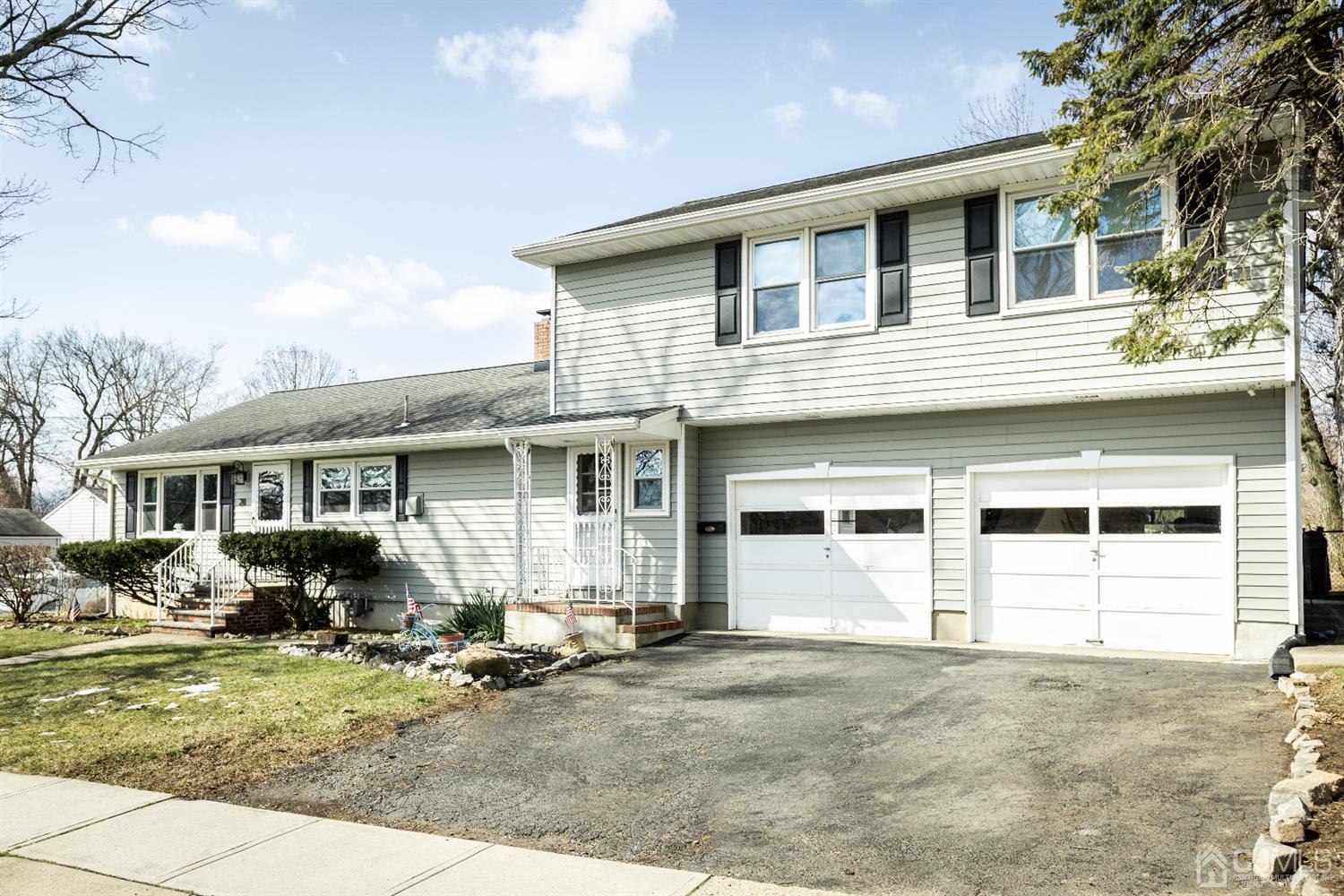 28 Melville Road Edison, NJ 08817 - Photo 3 of 52 a front view of a house with yard and seating space