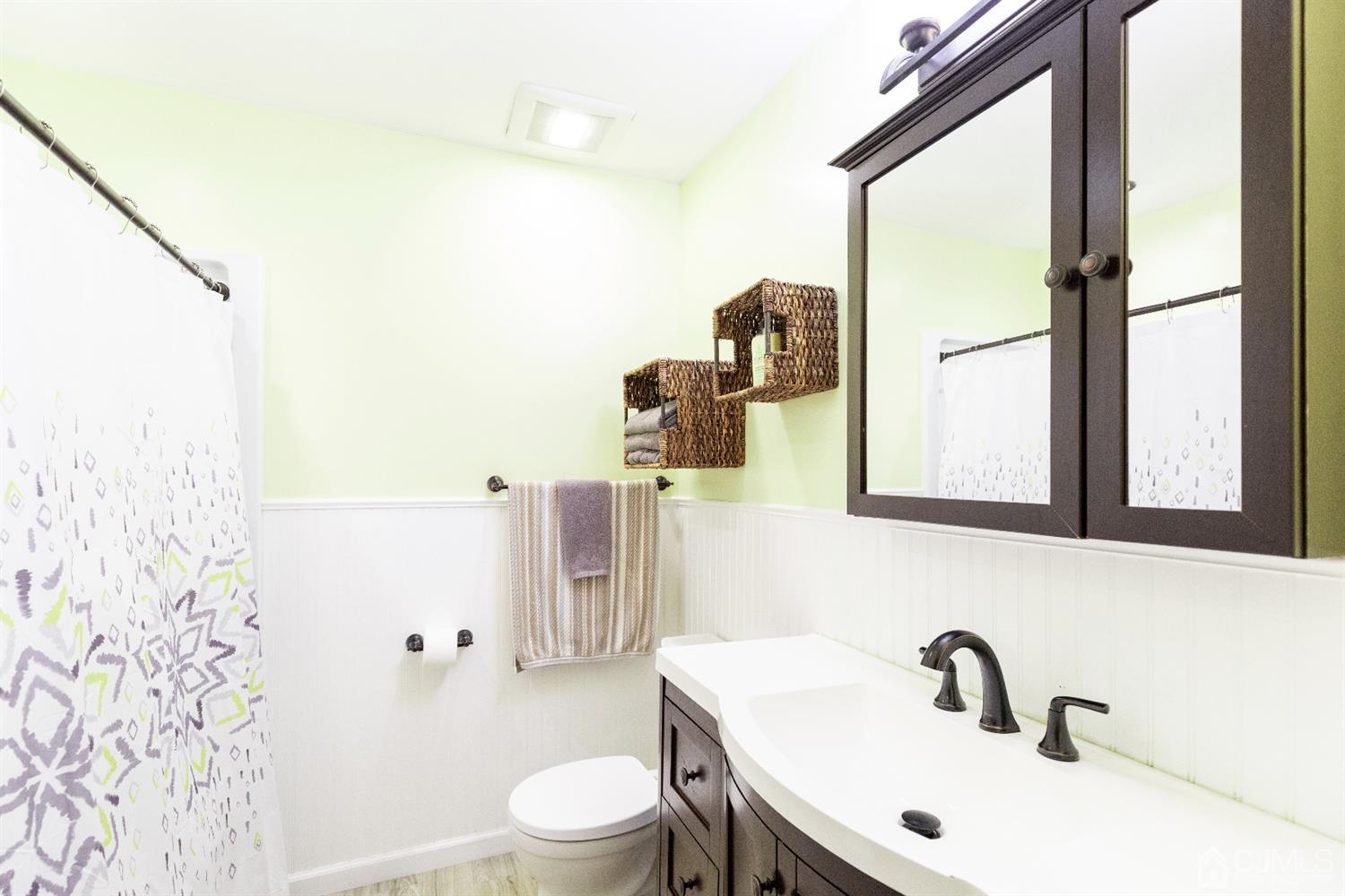 28 Melville Road Edison, NJ 08817 - Photo 23 of 52 a bathroom with a sink and a mirror