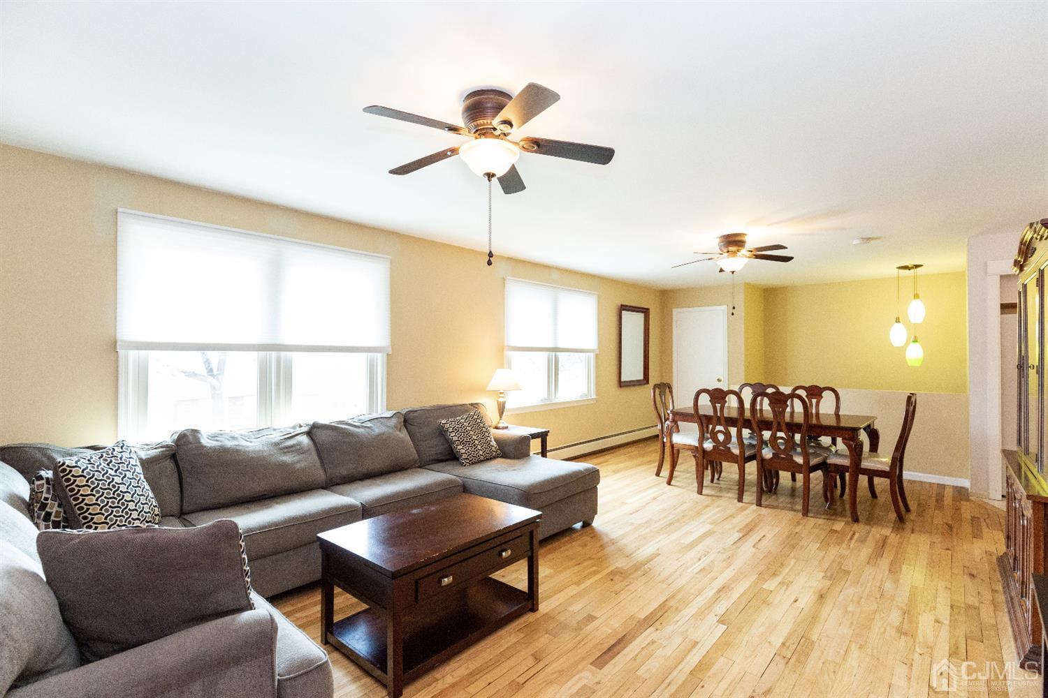 28 Melville Road Edison, NJ 08817 - Photo 32 of 52 a living room with furniture dining table and a large window