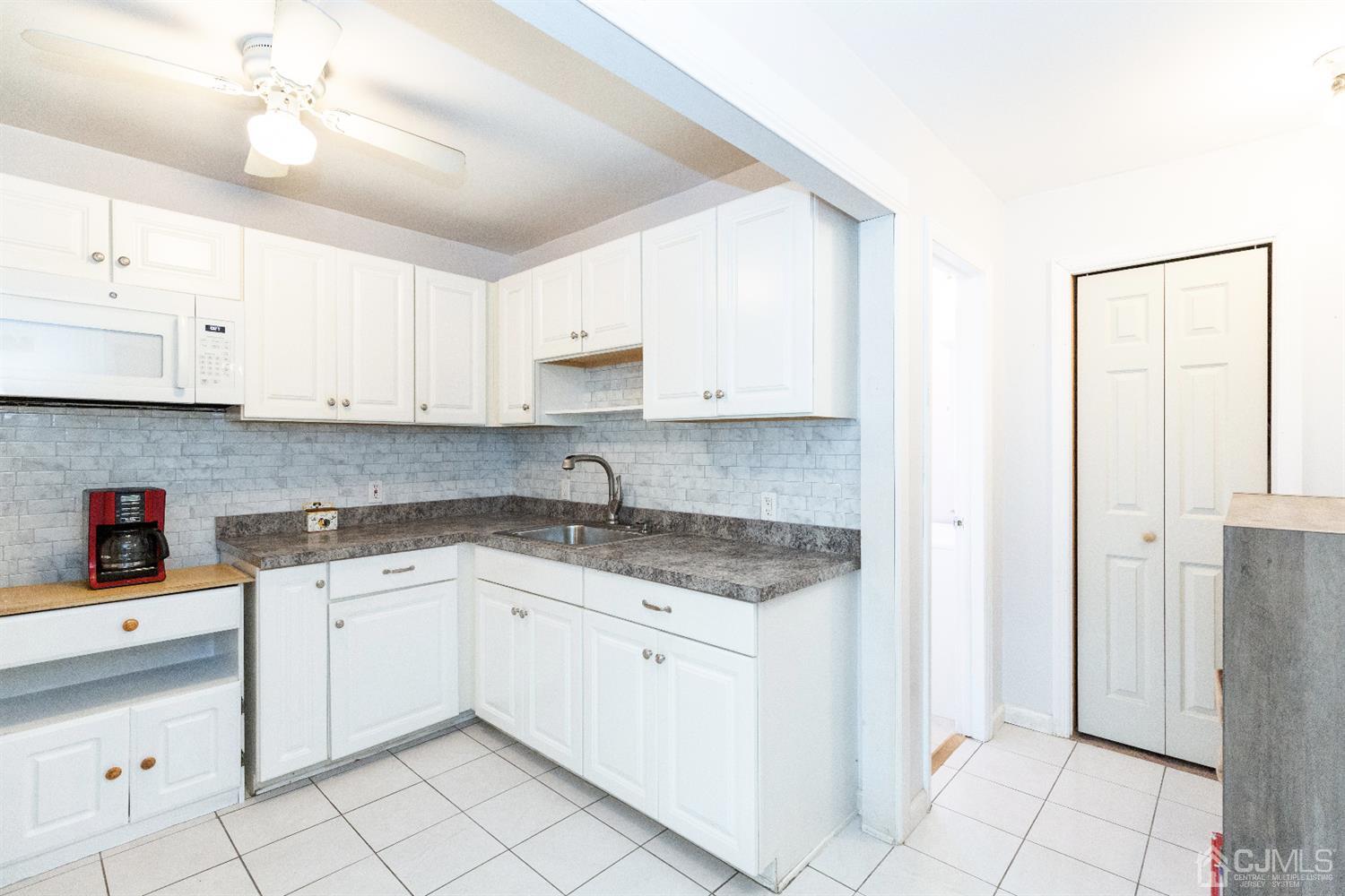 28 Melville Road Edison, NJ 08817 - Photo 34 of 52 a kitchen with stainless steel appliances granite countertop a sink and cabinets