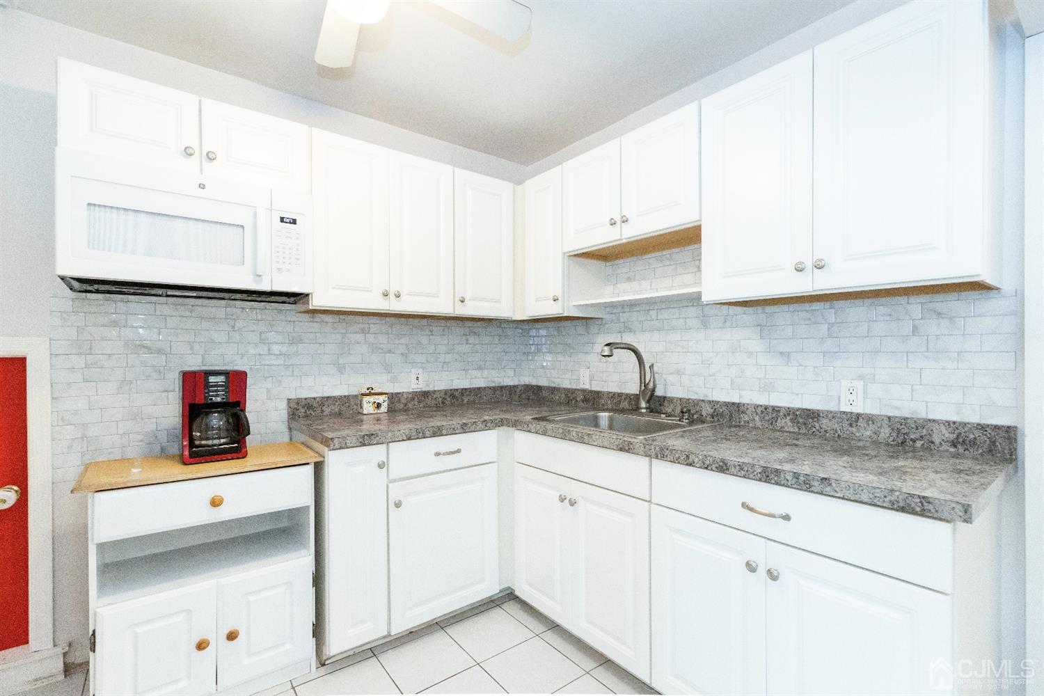 28 Melville Road Edison, NJ 08817 - Photo 35 of 52 a kitchen with stainless steel appliances granite countertop a sink stove and cabinets