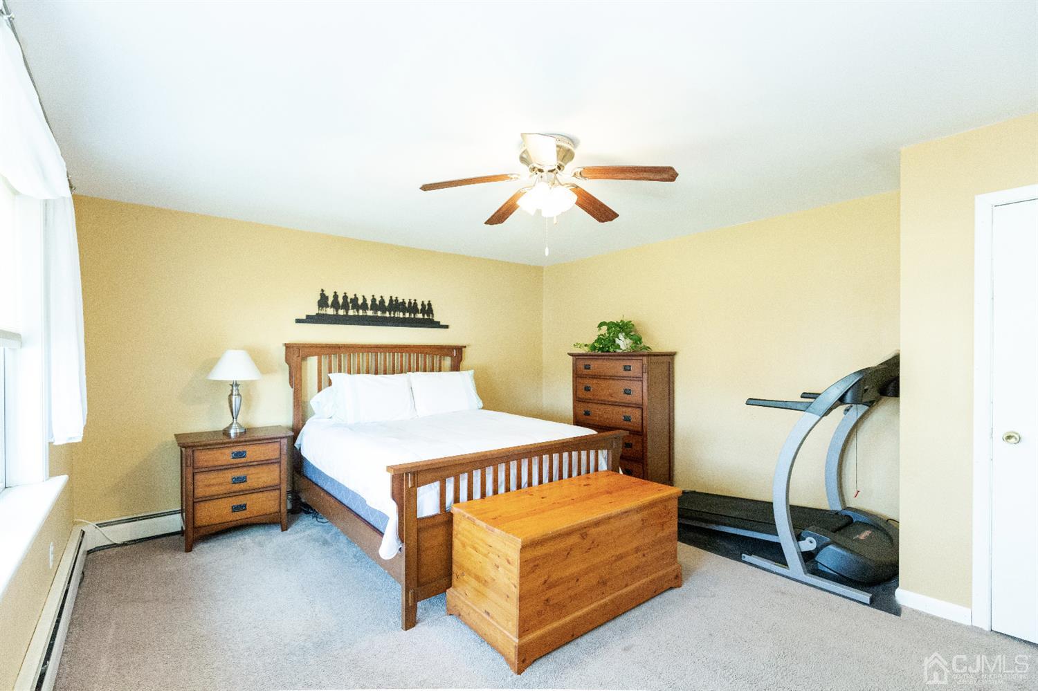 28 Melville Road Edison, NJ 08817 - Photo 38 of 52 a bedroom with a bed and a chandelier