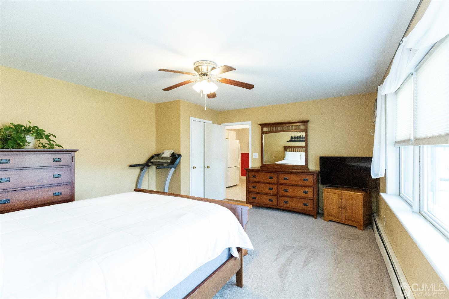 28 Melville Road Edison, NJ 08817 - Photo 39 of 52 a bedroom with a bed and a chandelier