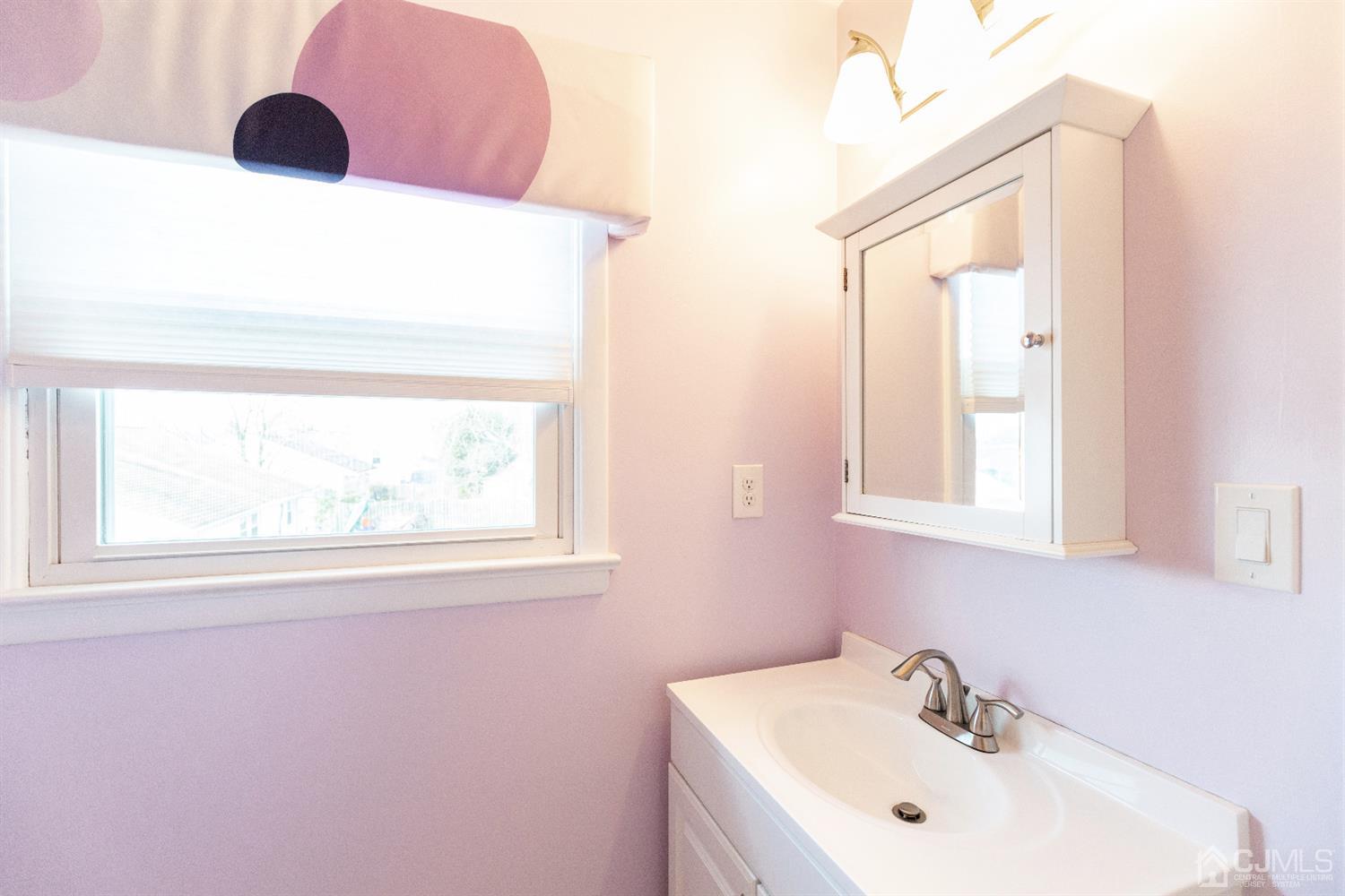 28 Melville Road Edison, NJ 08817 - Photo 41 of 52 a bathroom with a sink and a mirror