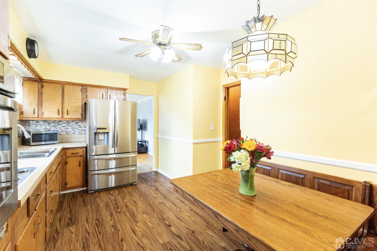 28 Melville Road Edison, NJ 08817 - Photo 10 of 52 a view of a dining room with furniture a chandelier and wooden floor