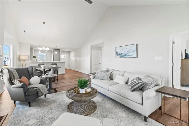 a living room with furniture and a chandelier