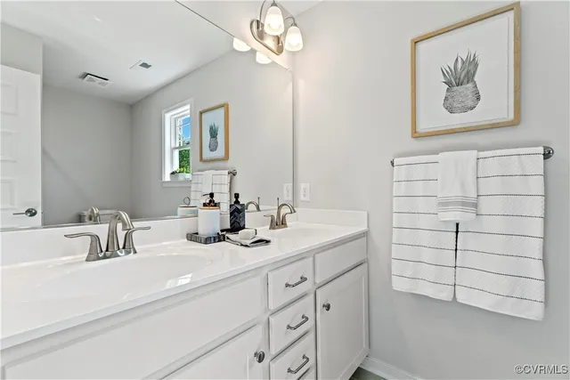 a bathroom with a sink a vanity and a mirror