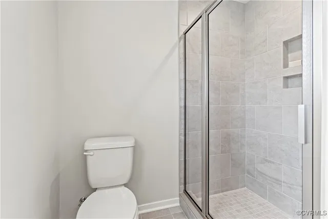 a white toilet sitting next to a bathroom