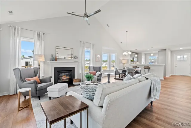 a living room with furniture a fireplace and a table