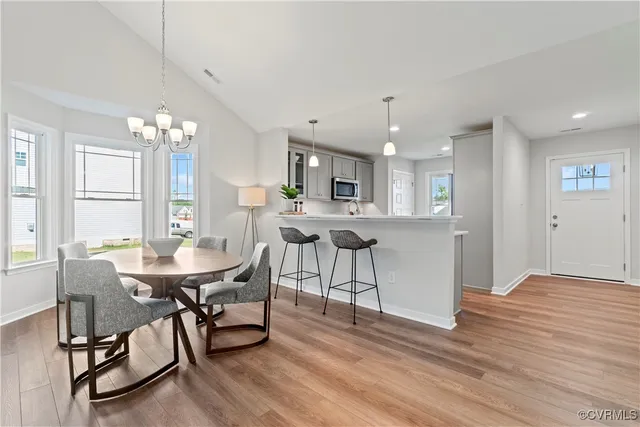 a view of a dining room with furniture and wooden floor