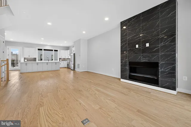a view of a kitchen with a sink and a fireplace