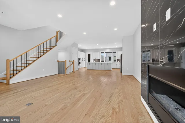 a view of a kitchen with cabinets and wooden floor