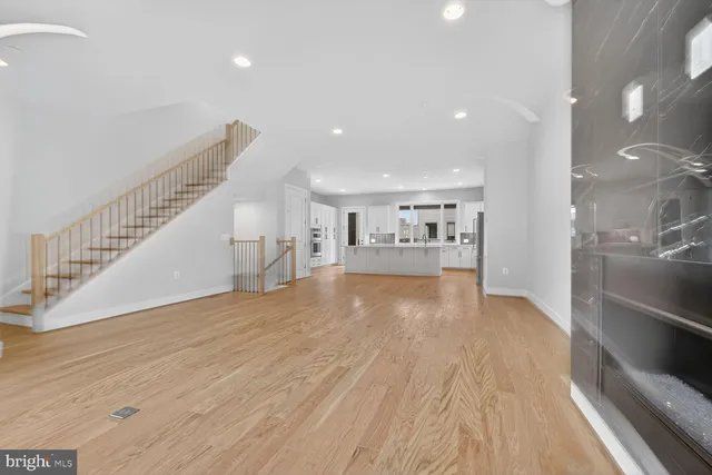 a view of kitchen and hall with wooden floor