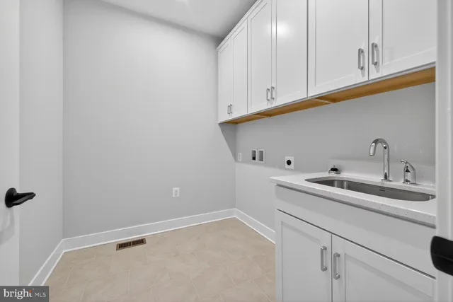 a view of an empty room with closet and a bathroom