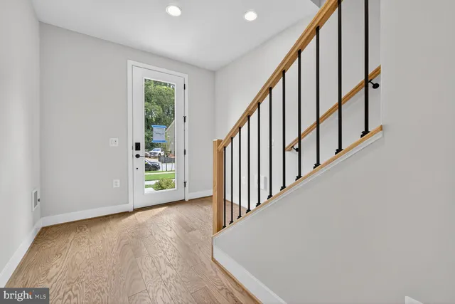 a view of an entryway with wooden floor