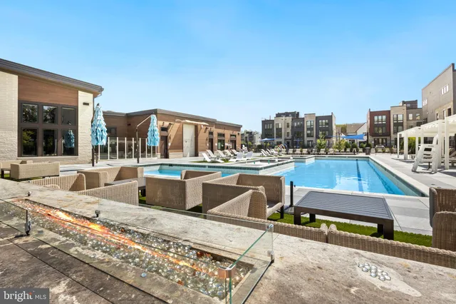 a view of a patio with table and chairs with barbeque grill and plants
