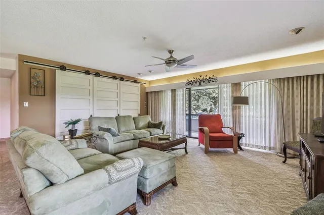 a kitchen with stainless steel appliances granite countertop a refrigerator a sink a stove and white cabinets