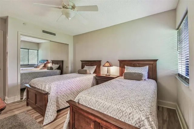 a bedroom with a large bed and a chandelier