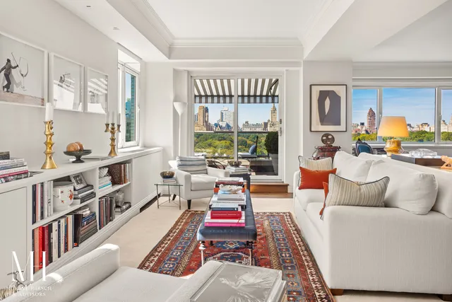 a living room with furniture and a book shelf