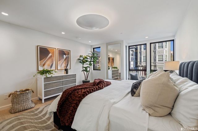 a bedroom with a large bed and a large window