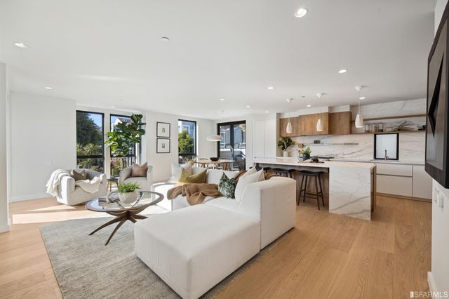 a living room with kitchen island furniture and a large window