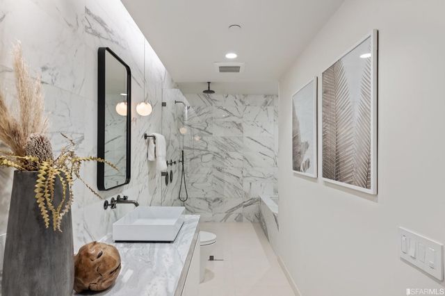 a bathroom with a tub sink and mirror