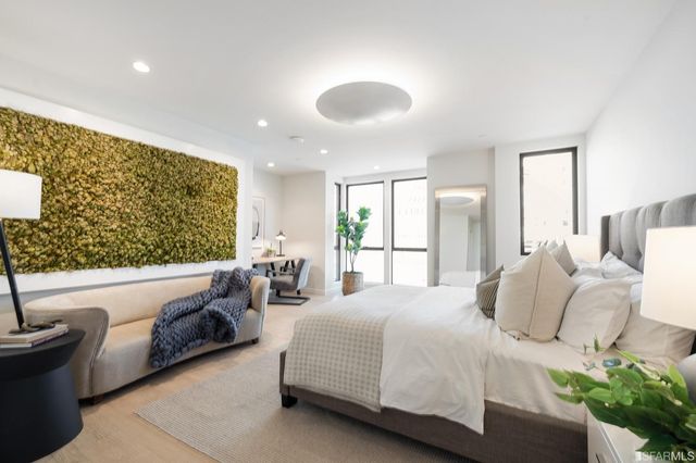 a spacious bedroom with a bed and a couch