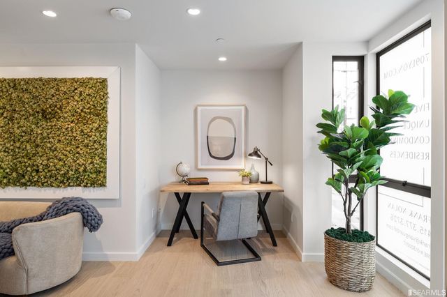 a dining room with furniture and a potted plant