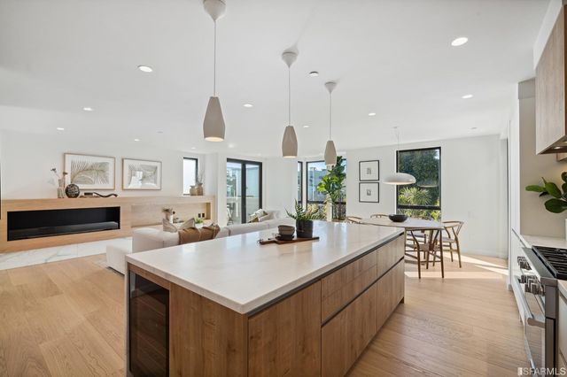 a view of kitchen island a sink and living room view