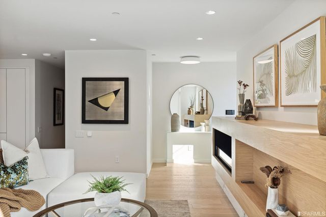 a large white kitchen with stainless steel appliances granite countertop a stove a sink and a refrigerator