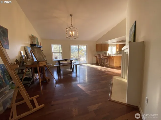 a view of a dining room with furniture wooden floor and a chandelier