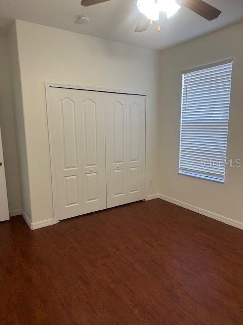 2614 Hartwood Pines Way Clermont, FL 34711 - Photo 11 of 25 an empty room with wooden floor closet and windows