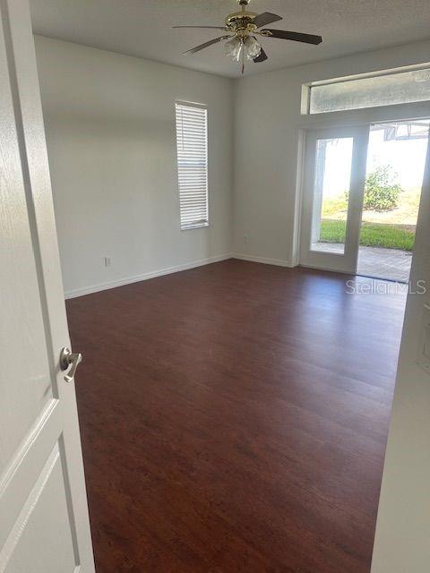 2614 Hartwood Pines Way Clermont, FL 34711 - Photo 13 of 25 an empty room with wooden floor and windows