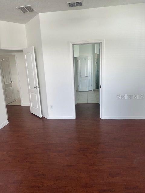 2614 Hartwood Pines Way Clermont, FL 34711 - Photo 14 of 25 an empty room with wooden floor and door