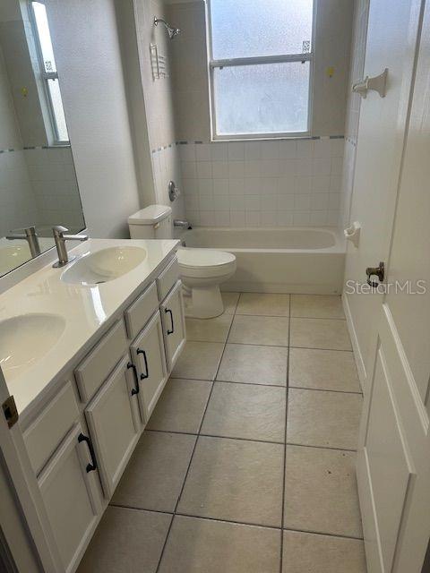 2614 Hartwood Pines Way Clermont, FL 34711 - Photo 17 of 25 a bathroom with a sink a toilet and a mirror
