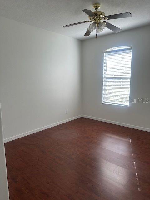 2614 Hartwood Pines Way Clermont, FL 34711 - Photo 18 of 25 an empty room with a window and a fan