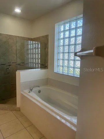 a bathroom with a bathtub and window