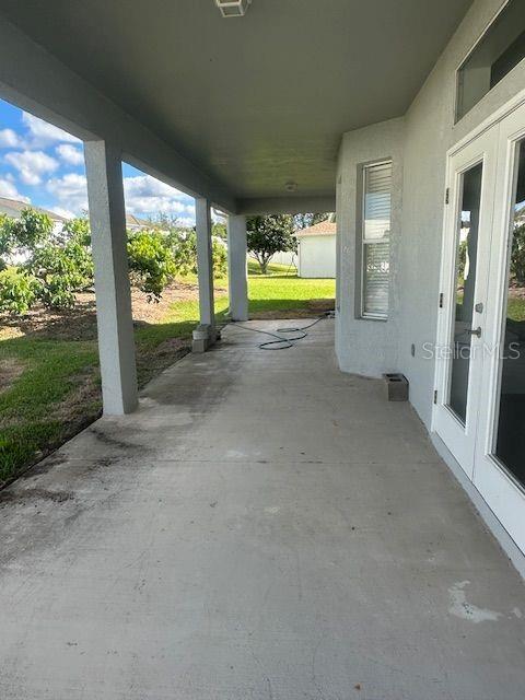 2614 Hartwood Pines Way Clermont, FL 34711 - Photo 23 of 25 a view of an empty room with a floor to ceiling window and a yard