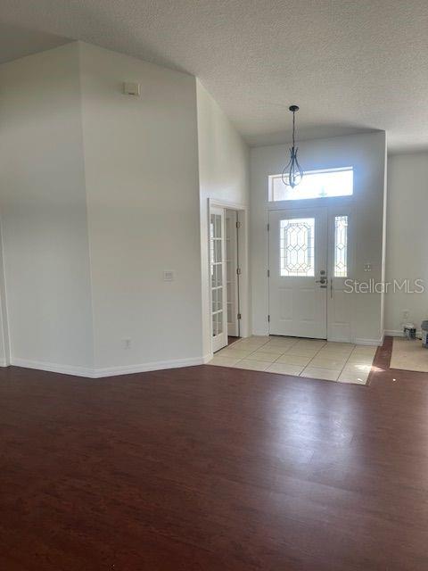 2614 Hartwood Pines Way Clermont, FL 34711 - Photo 3 of 25 an empty room with wooden floor and mirror