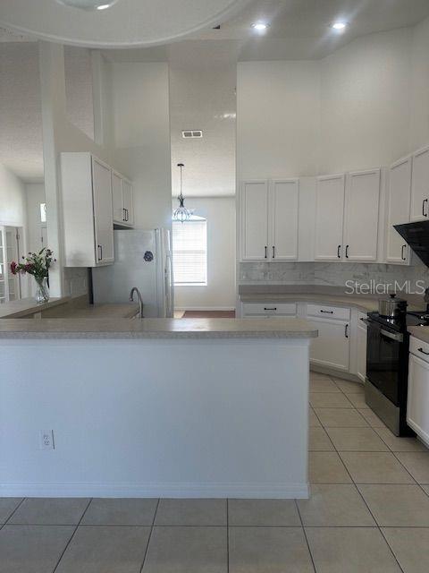 2614 Hartwood Pines Way Clermont, FL 34711 - Photo 5 of 25 a kitchen with stainless steel appliances granite countertop a sink and a stove