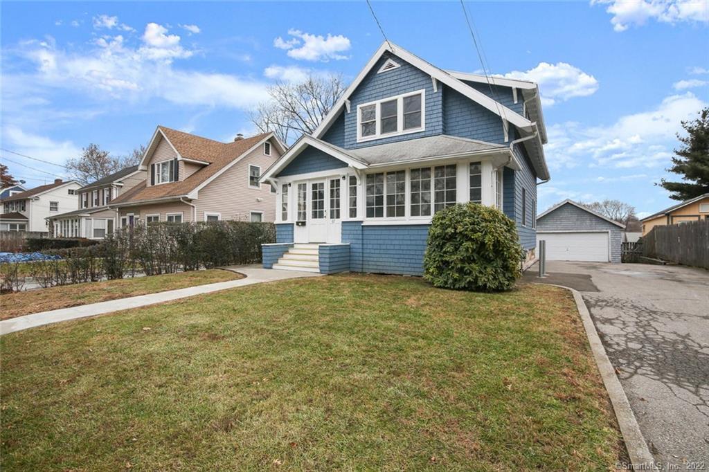 67 Clovelly Road Stamford, CT 06902 - Photo 1 of 1 a front view of a house with a yard and garage