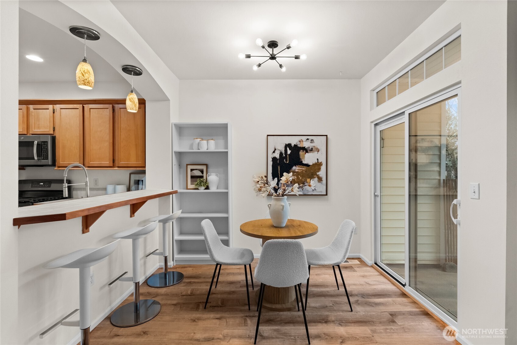 18708 109 Lane Southeast, Unit K30 Renton, WA 98055 - Photo 14 of 36 a view of a dining room with furniture and chandelier