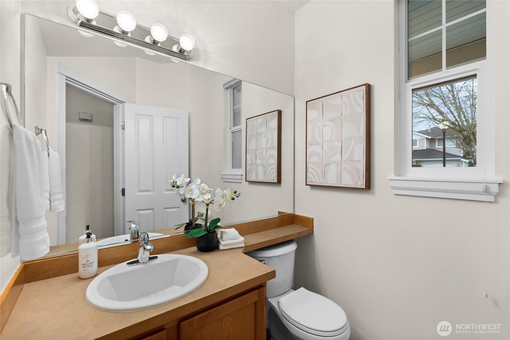 18708 109 Lane Southeast, Unit K30 Renton, WA 98055 - Photo 25 of 36 a bathroom with a toilet sink and mirror