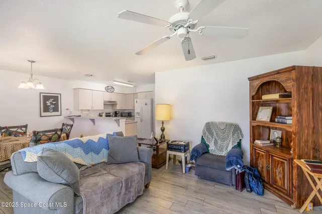 a living room with furniture a rug and a bookshelf