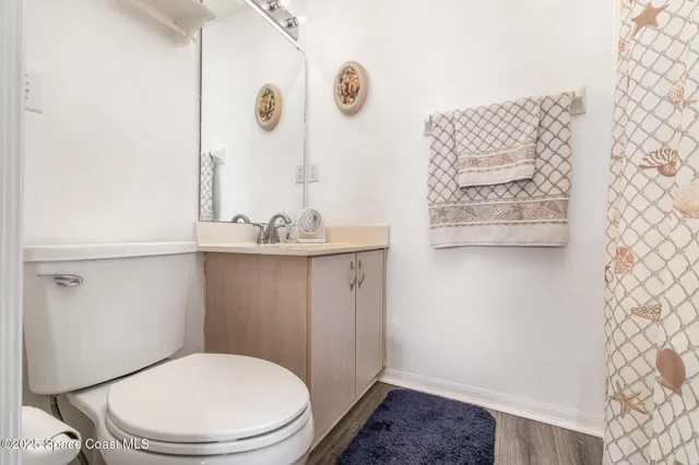 a bathroom with a toilet a sink and a shower