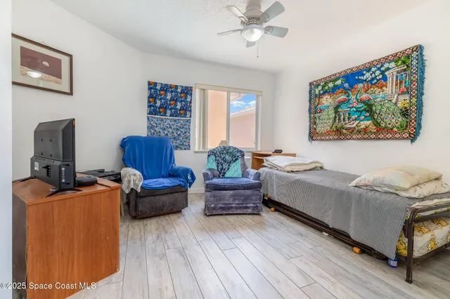 a bedroom with furniture and a window